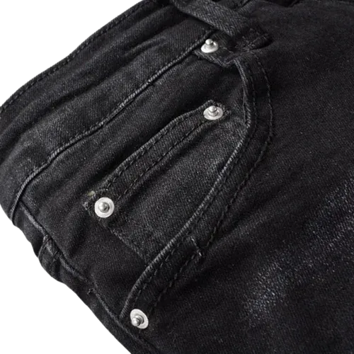 Pantalon vaquero negro rasgado con detalles de cachemira